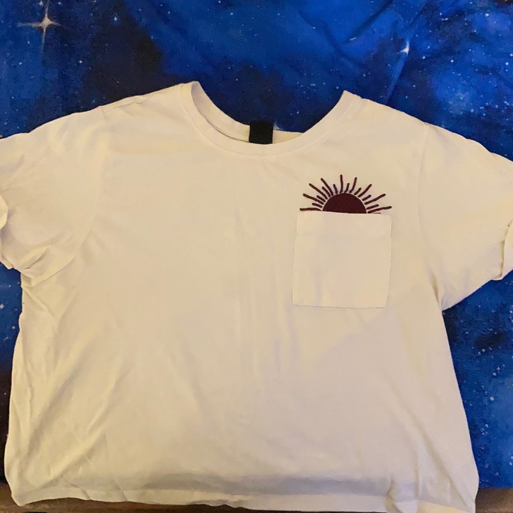 White crop top, with sun coming out the pocket